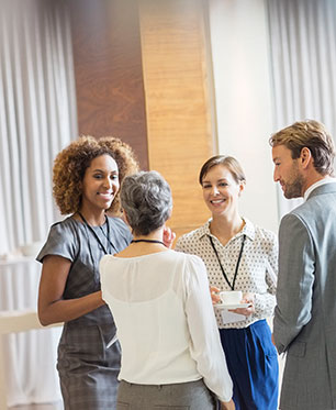 four professionals mingling at networking event